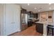 Kitchen with stainless steel appliances, a gray speckled granite countertop, dark cabinets, and wood-look tile flooring at 38144 W San Clemente St, Maricopa, AZ 85138