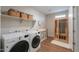Laundry room with washer, dryer, shelves and adjacent infrared sauna at 38144 W San Clemente St, Maricopa, AZ 85138