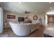 Bright living room with wood floors, ceiling fan, and comfortable sofa seating at 38144 W San Clemente St, Maricopa, AZ 85138