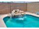Beautiful backyard pool featuring a rock waterfall, perfect for relaxing and enjoying the outdoors at 38144 W San Clemente St, Maricopa, AZ 85138
