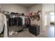 Well-organized walk-in closet with shelves, rods, and drawers for maximum storage at 38144 W San Clemente St, Maricopa, AZ 85138