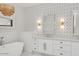 Bright bathroom features a freestanding tub, double vanity with geometric wallpaper and stylish light fixture at 3924 E Roma Ave, Phoenix, AZ 85018