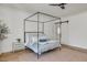 Serene bedroom with a four-poster bed, hardwood floors, and ensuite bathroom at 3924 E Roma Ave, Phoenix, AZ 85018