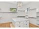 Spacious walk-in closet with custom shelving, center island, and wood floors offers ample storage and organization at 3924 E Roma Ave, Phoenix, AZ 85018