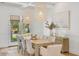 Elegant dining room with modern lighting and a large table with seating for eight at 3924 E Roma Ave, Phoenix, AZ 85018