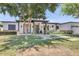 Inviting front exterior with lush lawn, mature tree, and covered entryway at 3924 E Roma Ave, Phoenix, AZ 85018