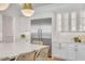 Bright, modern kitchen featuring quartz countertops, stainless steel appliances, and custom white cabinets at 3924 E Roma Ave, Phoenix, AZ 85018