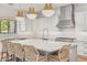 Bright, modern kitchen featuring an island with seating, quartz countertops, and stainless steel appliances at 3924 E Roma Ave, Phoenix, AZ 85018