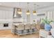 Bright, modern kitchen featuring an island with seating, stainless steel appliances, and pendant lighting at 3924 E Roma Ave, Phoenix, AZ 85018