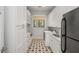 Functional laundry room with modern appliances, custom cabinetry, and stylish flooring offers convenience and organization at 3924 E Roma Ave, Phoenix, AZ 85018