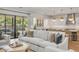 Bright living room with white sectional sofa, hardwood floors, and modern kitchen with breakfast bar at 3924 E Roma Ave, Phoenix, AZ 85018