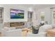 Bright living room featuring a fireplace, built-in cabinets, and a large television at 3924 E Roma Ave, Phoenix, AZ 85018