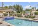 Inviting pool and spa area with a covered patio, basketball court, and comfortable lounge chairs at 3924 E Roma Ave, Phoenix, AZ 85018