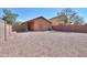 A spacious gravel backyard, perfect for low-maintenance landscaping and outdoor activities at 40468 W Sanders Way, Maricopa, AZ 85138