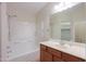 Bathroom with a single vanity, mirror, white shower-tub combo, and tile flooring for easy maintenance at 40468 W Sanders Way, Maricopa, AZ 85138
