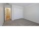 Bedroom with carpet floor and white closet at 40468 W Sanders Way, Maricopa, AZ 85138