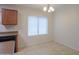 Bright dining area features tile floors, large window, and modern light fixture at 40468 W Sanders Way, Maricopa, AZ 85138