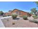 Charming single-story home featuring desert landscaping, a tile roof, and an inviting curb appeal at 40468 W Sanders Way, Maricopa, AZ 85138