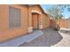 A well-maintained front entrance with a secure screen door and a tidy, desert-style garden at 40468 W Sanders Way, Maricopa, AZ 85138