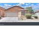 Inviting single-story home with a neutral color scheme, well-maintained landscaping, and an attached two-car garage at 40468 W Sanders Way, Maricopa, AZ 85138