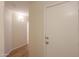 Hallway with wood floor and white door at 40468 W Sanders Way, Maricopa, AZ 85138
