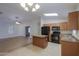 Open kitchen boasts center island and seamlessly connects to living area at 40468 W Sanders Way, Maricopa, AZ 85138