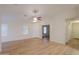 Spacious living room with lots of natural light and wood-look floors, perfect for entertaining at 40468 W Sanders Way, Maricopa, AZ 85138
