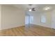 Inviting living area with abundant natural light and wood-look floors, ready for personalized touches at 40468 W Sanders Way, Maricopa, AZ 85138