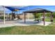 Neighborhood playground with slides, play structures, a picnic table and shade from a park shelter at 40468 W Sanders Way, Maricopa, AZ 85138