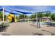 Community playground featuring a slide, climbing structure, swings, and shaded canopies at 40468 W Sanders Way, Maricopa, AZ 85138