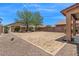 Backyard ready for landscaping, featuring gravel, pavers, and block wall at 4380 W White Canyon Rd, San Tan Valley, AZ 85144
