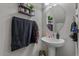 Half bathroom with pedestal sink and neutral decor, creating a refreshing and practical space at 4380 W White Canyon Rd, San Tan Valley, AZ 85144
