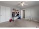 Comfortable bedroom with neutral carpet, desk, shelving and closet at 4380 W White Canyon Rd, San Tan Valley, AZ 85144