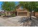 Charming two-story home with a well-manicured front yard and a two-car garage at 4380 W White Canyon Rd, San Tan Valley, AZ 85144