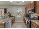 Well-equipped kitchen with granite countertops, stainless steel appliances, and ample cabinet space at 4380 W White Canyon Rd, San Tan Valley, AZ 85144