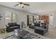 Cozy living room with a comfortable sofa, contemporary decor, and an adjacent dining area at 4380 W White Canyon Rd, San Tan Valley, AZ 85144