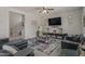 Well-decorated living room with a plush sectional sofa, modern decor, and a large TV at 4380 W White Canyon Rd, San Tan Valley, AZ 85144