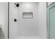 Walk-in shower with subway tile, niche, black hardware, and a light blue glass panel at 5230 E Brown Rd # 114, Mesa, AZ 85205