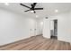 Bedroom features luxury vinyl plank flooring, ceiling fan, two closets, and attached bath at 5230 E Brown Rd # 114, Mesa, AZ 85205