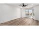 Bedroom features luxury vinyl plank flooring, large window providing ample natural light, and neutral paint at 5230 E Brown Rd # 114, Mesa, AZ 85205