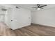 Bright bedroom features modern light fixture, light wood floors and fresh white walls at 5230 E Brown Rd # 114, Mesa, AZ 85205