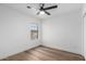 Bright bedroom featuring a ceiling fan, and wood-look flooring with natural light at 5230 E Brown Rd # 114, Mesa, AZ 85205