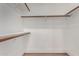 A well-organized walk-in closet with wooden rods and shelving offers ample storage at 5230 E Brown Rd # 114, Mesa, AZ 85205