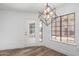 Bright dining room features luxury vinyl plank flooring, stylish lighting, a large window, and door to the yard at 5230 E Brown Rd # 114, Mesa, AZ 85205