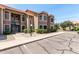 Two-story condo building featuring desert landscaping, a red tile roof, and convenient parking at 5230 E Brown Rd # 114, Mesa, AZ 85205