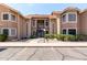 Two-story condo building with desert landscaping, a red tile roof, and private entry stairs at 5230 E Brown Rd # 114, Mesa, AZ 85205