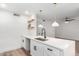 Bright kitchen features a stainless sink, white cabinets, quartz countertop, and a stylish faucet at 5230 E Brown Rd # 114, Mesa, AZ 85205