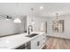 Open concept kitchen features stone countertops, stainless steel appliances, and modern lights at 5230 E Brown Rd # 114, Mesa, AZ 85205