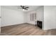 Bright living room features wood floors, fireplace, and a modern ceiling fan at 5230 E Brown Rd # 114, Mesa, AZ 85205