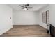 Bright living room with wood floors, modern ceiling fan, and cozy fireplace at 5230 E Brown Rd # 114, Mesa, AZ 85205